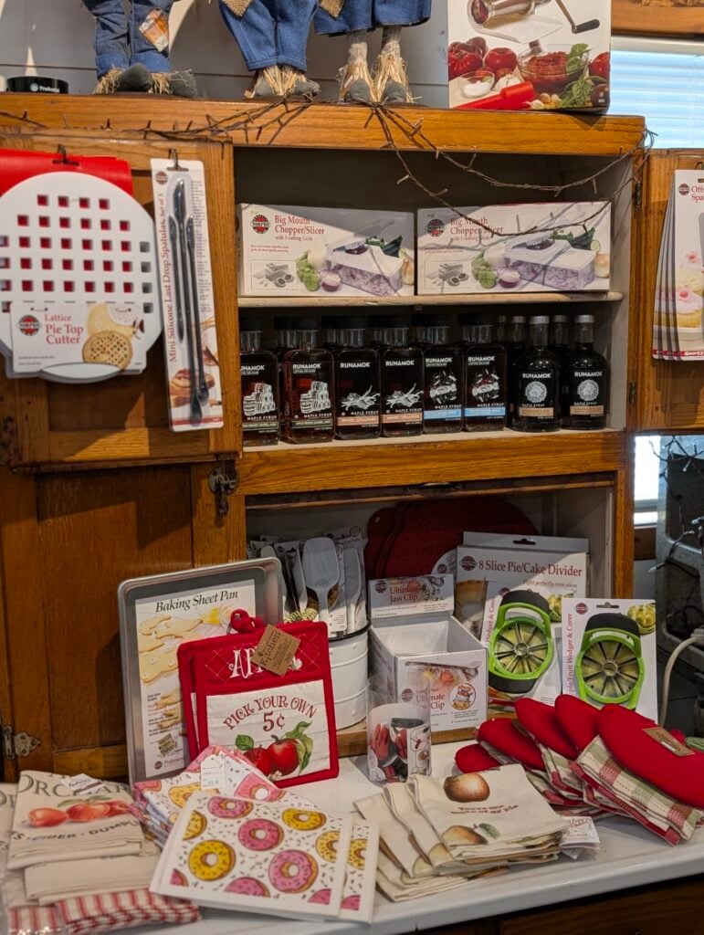 Kitchen gadgets and decor on wooden shelves.