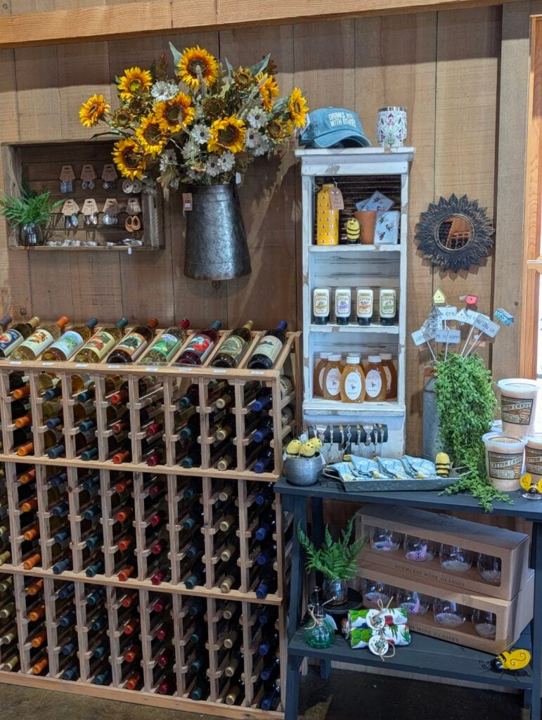 Wine rack with sunflowers and various store goods