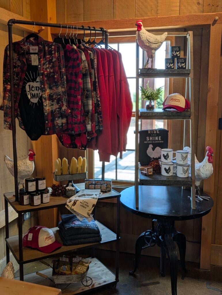 Farm-themed merchandise display with shirts and mugs.