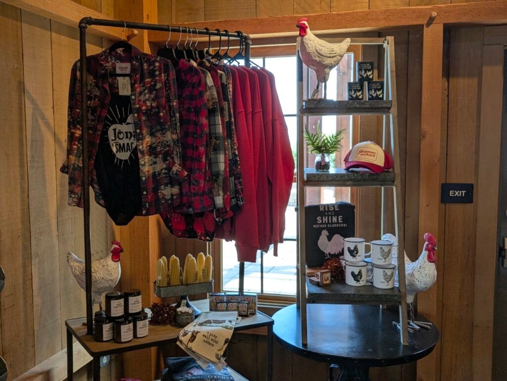 Farm-themed clothing and decor display with roosters.