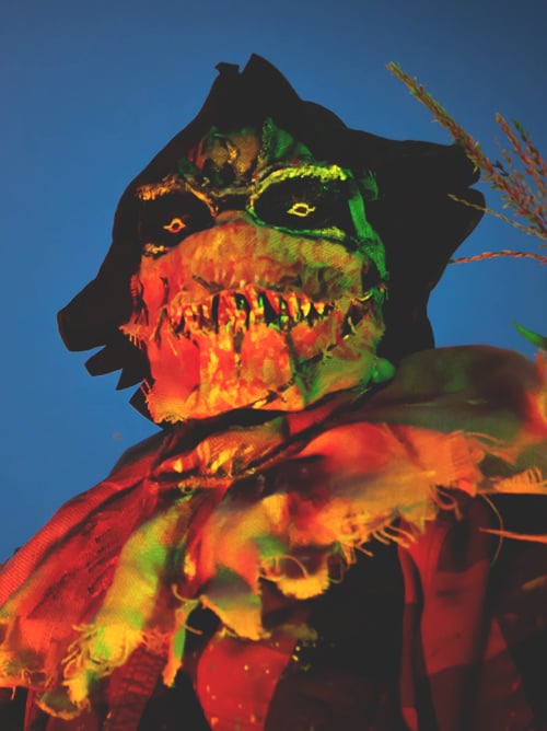 Scary monster in glowing costume at night