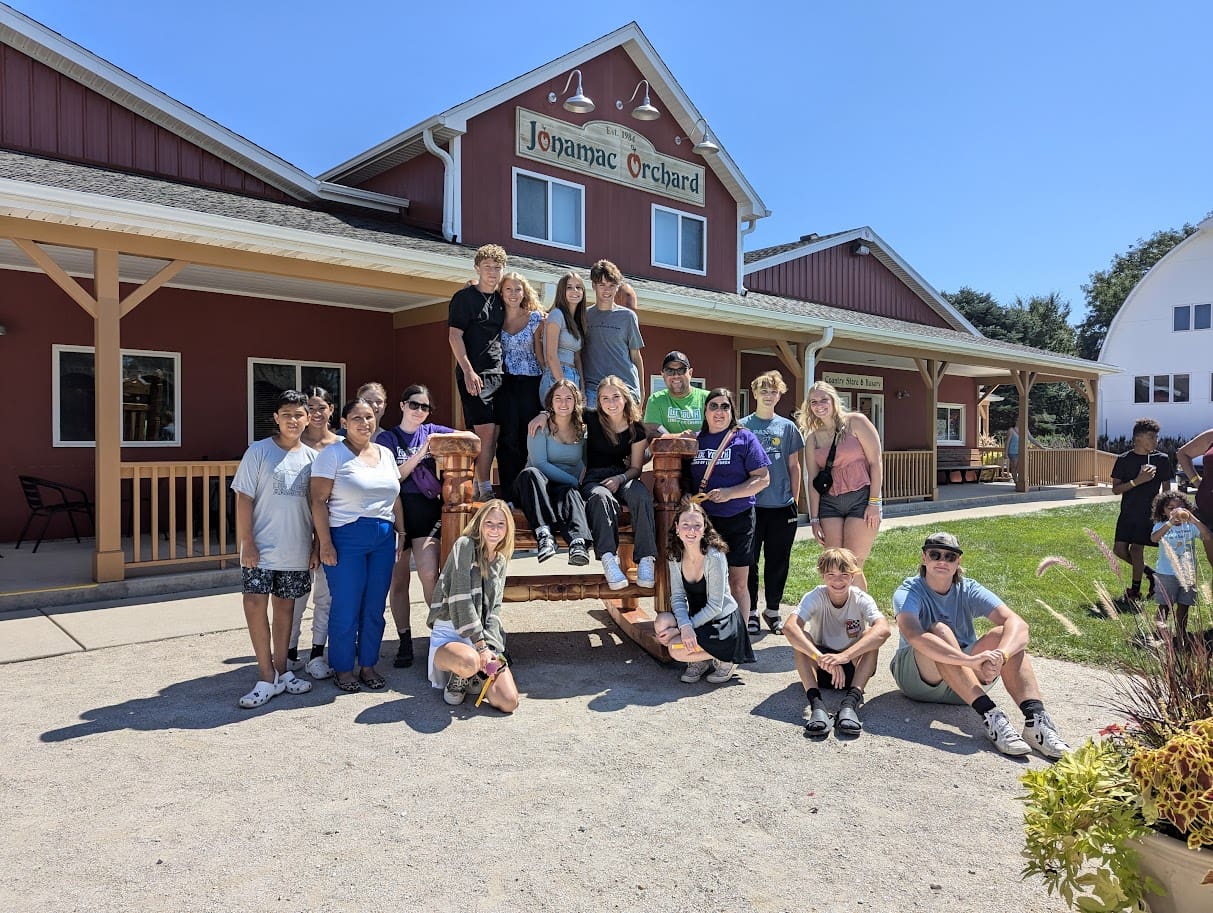 Group of people at Jonamac Orchard entrance.